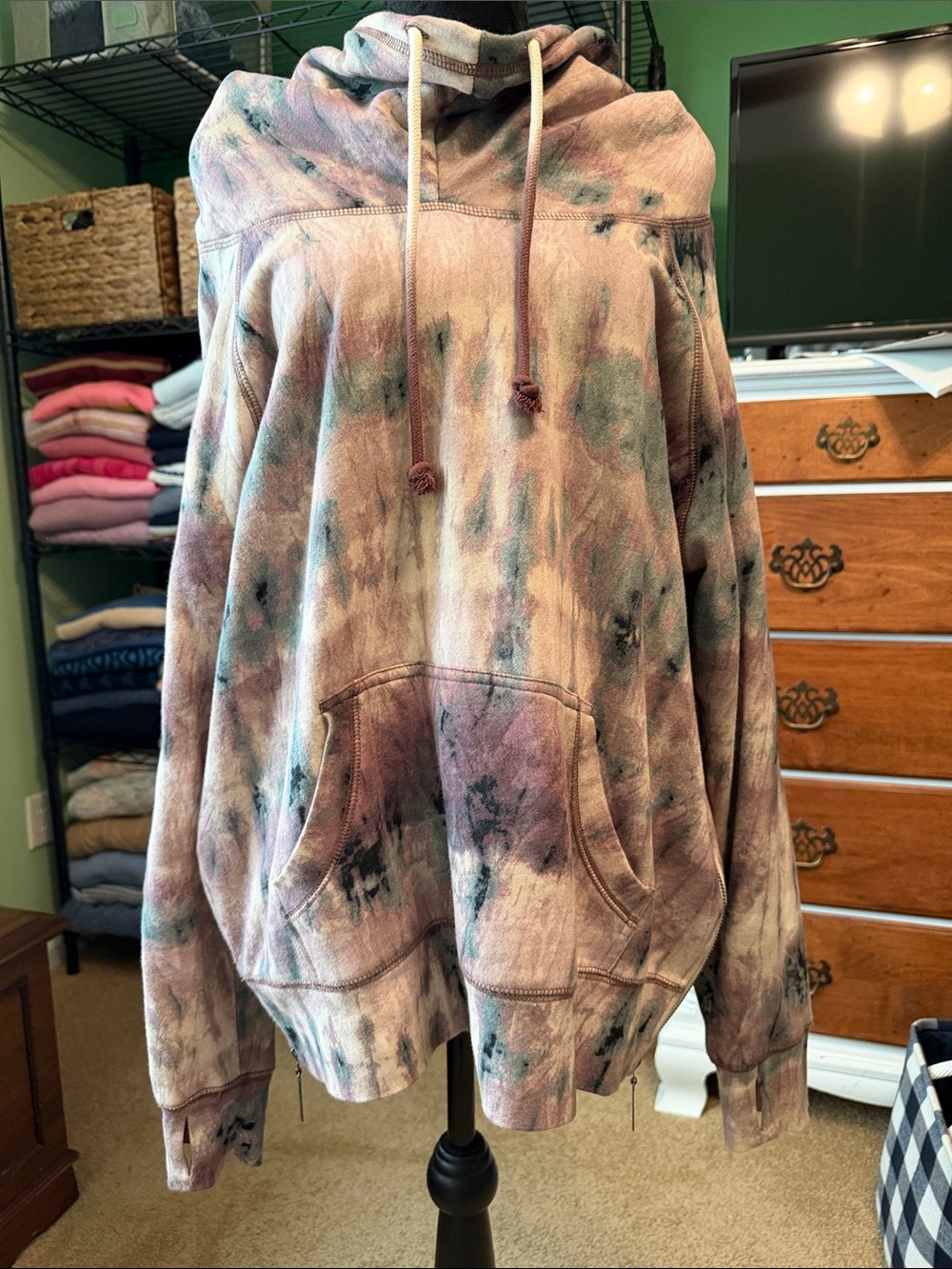 Peace Love World Tie-Dye Pullover Hoodie in mauve, green and beige.